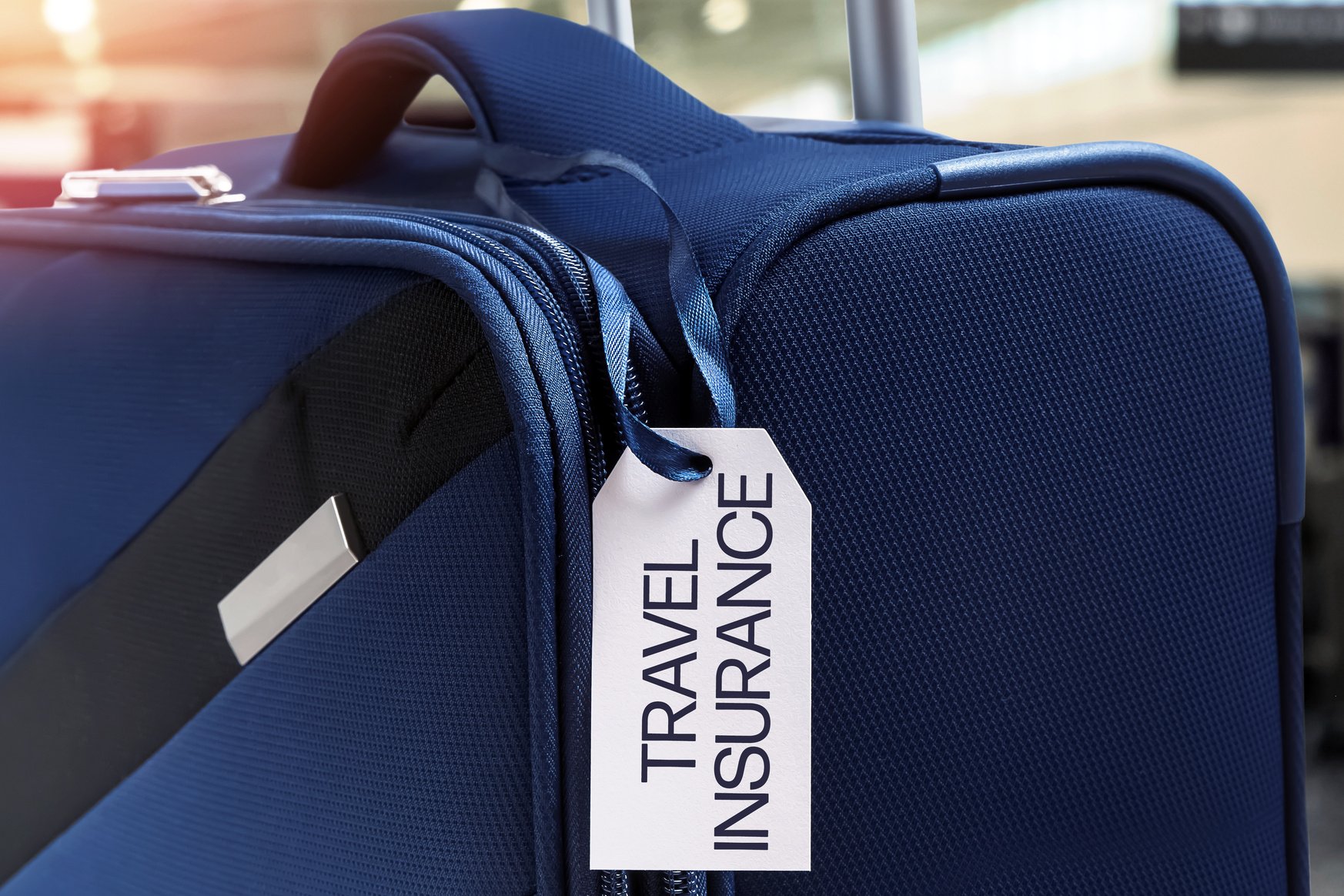 Blue Suitcase with Travel Insurance Label